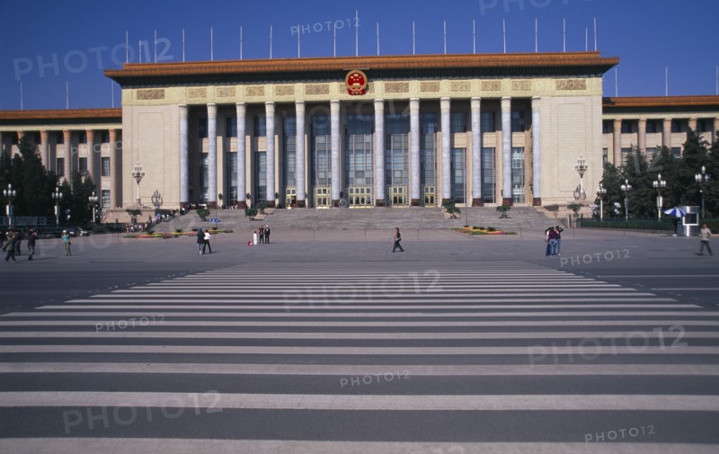CHINA, Beijing, "Tiananmen Square.  Great Hall of the People, venue of the National people’s Congress with visitors in queue on steps to entrance and other crossing square in foreground."