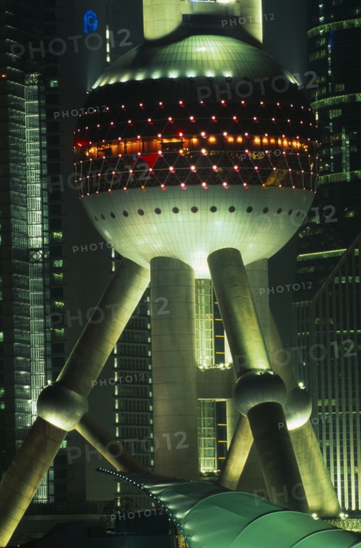 CHINA, Shanghai, Part view of the Oriental Pearl Tower exterior illuminated at night.