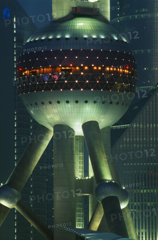 CHINA, Shanghai, Part view of the Oriental Pearl Tower exterior illuminated at night.