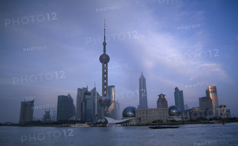 CHINA, Shanghai, Pudong skyline at dusk with skyscrapers including the Oriental Pearl Tower and the Jin Mao Building.