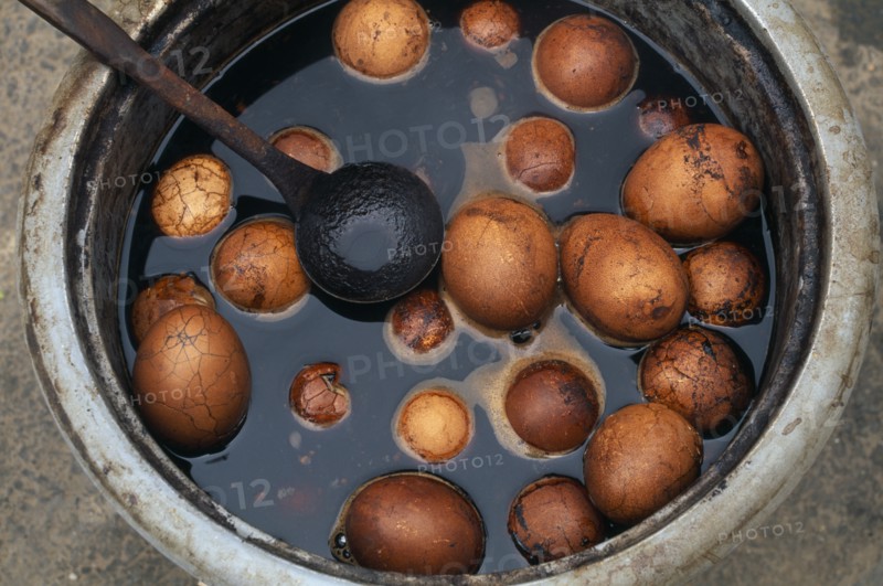 CHINA, Beijing, Pickled eggs in bowl with ladle.