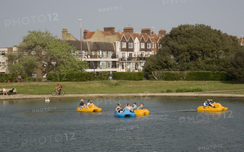 ENGLAND, West Sussex, Littlehampton, Families enjoying pedal boat rides at Oyster Pond Boating Lake