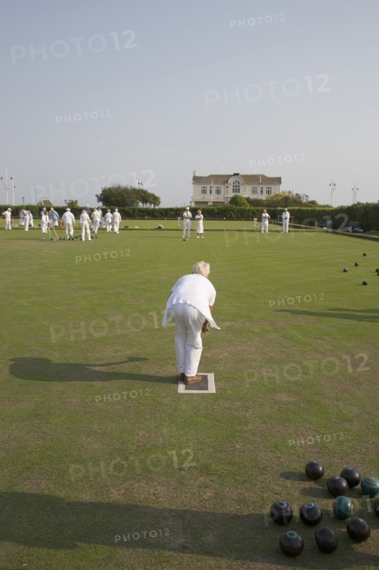 ENGLAND, West Sussex, Bognor Regis, Men and women playing a game of bowls on beach front green