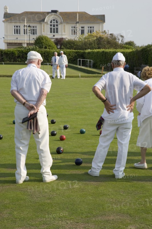 ENGLAND, West Sussex, Bognor Regis, Men and women playing a game of bowls on beach front green