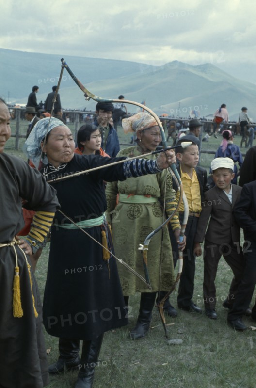 MONGOLIA, Ulan Bator, Nadam  National Day Ulan Bator Stadium Woman competitor taking part in national archery competition. Ulaanbaatar East Asia Asian Baator Female Woman Girl Lady Mongol Uls Mongolian Ulaan