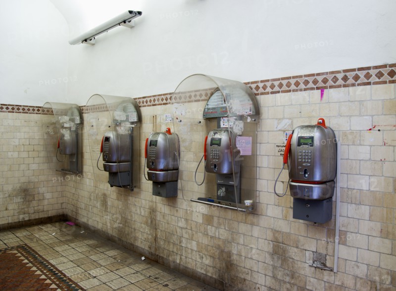 ITALY, Tuscany, Siena, Five public phone boxes in a tiled room