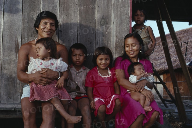 COLOMBIA, North West Amazon, Tukano Indigenous People, Makuna family - Venancio one of headman Bosco' sons  with his wife and five children outside their recently constructed small family home. Venancio is the teacher in the local Makuna school   Makuna Indian North Western Amazonia  cassava American Colombian Columbia Hispanic Indegent Latin America Latino Male Men Guy South