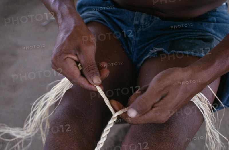 COLOMBIA, North West Amazon, Tukano Indigenous People, Close-up of Makuna man making cumare palm fibre rope. Tukano  Makuna Indian North Western Amazonia American Colombian Columbia Fiber Hispanic Indegent Latin America Latino Male Men Guy South America Tukano