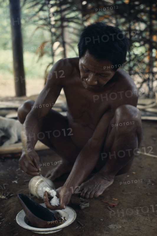 COLOMBIA, North West Amazon, Vaupes, Maku hunter Umero taking salt - a valued commodity  from bottle. indigenous tribe indian nomadic American Colombian Columbia Hispanic Indegent Latin America Latino Male Men Guy South America Vaupes Male Man Guy One individual Solo Lone Solitary Vaupes