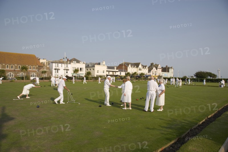 ENGLAND, West Sussex, Bognor Regis, Men and women playing a game of bowls on beach front green