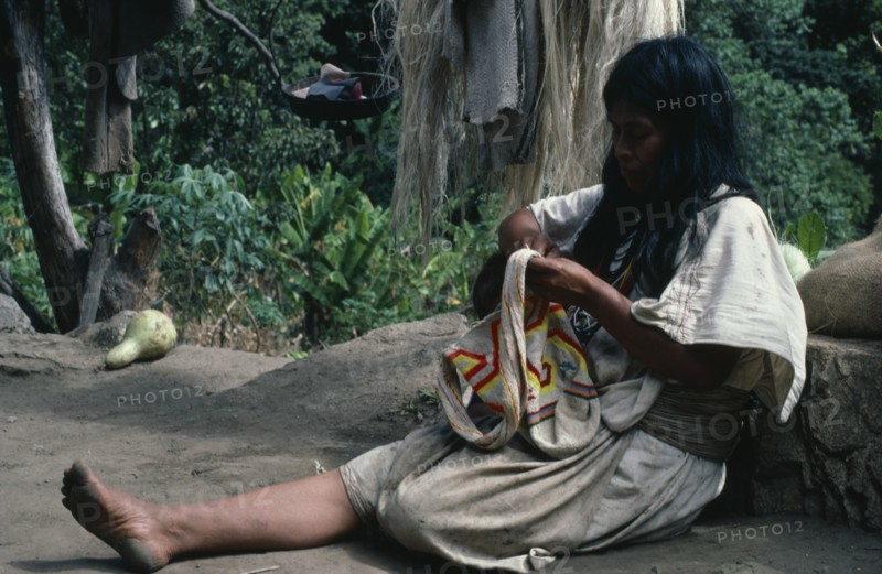COLOMBIA, Sierra Nevada de Santa Marta, Ika, Ika woman in traditional wool&cotton manta cloak sewing a coloured wool mochila shoulder bag in which men and women carry personal belongings. Arhuaco Aruaco indigenous tribe American Classic Classical Colombian Colombia Female Women Girl Lady Hispanic Historical Indegent Kids Latin America Latino Older South America  Arhuaco Aruaco indigenous tribe American Classic Classical Colombian Columbia Female Women Girl Lady Hispanic Historical Indegent Kids Latin America Latino Older South America Female Woman Girl Lady History One individual Solo Lone Solitary 1 Colored Male Man Guy Single unitary
