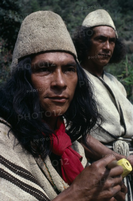 COLOMBIA, Sierra Nevada de Santa Marta, Ika, Head and shoulders portrait of two Ika men in traditional dress. Helmets made from fique cactus fibre and mantas cloaks from woven wool&cotton. Both members of the powerful Villafana family Arhuaco Aruaco indigenous tribe American Classic Classical Colombian Colombia Hispanic Historical Indegent Latin America Latino Male Man Guy Older South America  Arhuaco Aruaco indigenous tribe American Classic Classical Colombian Columbia Hispanic Historical Indegent Latin America Latino Male Man Guy Older South America 2 History Male Men Guy Fiber