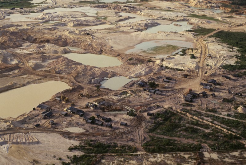 BRAZIL, Mato Grosso, Peixoto de Azevedo, Gold mine on former Panara territory showing miners settlement and mercury washing pools  deforestation and pollution.Garimpeiro                      prospectors have displaced the Panara  formerly known as Kreen-Akrore  Krenhakarore  Krenakore  Krenakarore  Amazon American Brasil Brazilian Ecology Entorno Environmental Environment Green Issues Kreen Akore Latin America Latino Scenic South America