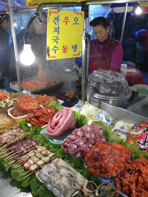 KOREA, South, Seoul, "Namdaemun - Namdaemun Market, December evening, food stall with chicken, meat, and fish waiting to be cooked"