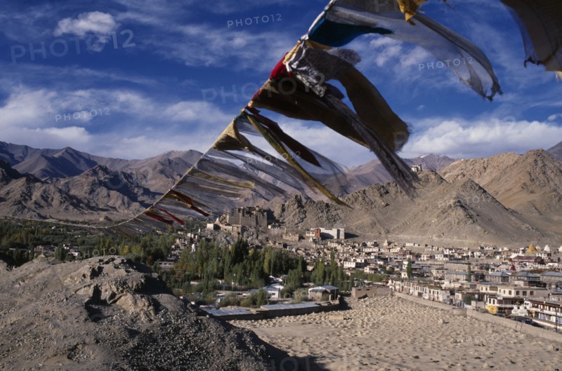 INDIA, Ladakh, Leh, Prayer flags on hillside above Leh spread out across valley below.
