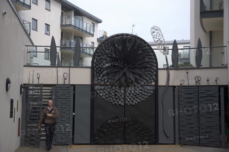 ENGLAND, East Sussex, Brighton, Ornate gates to new housing apartment development in West street.