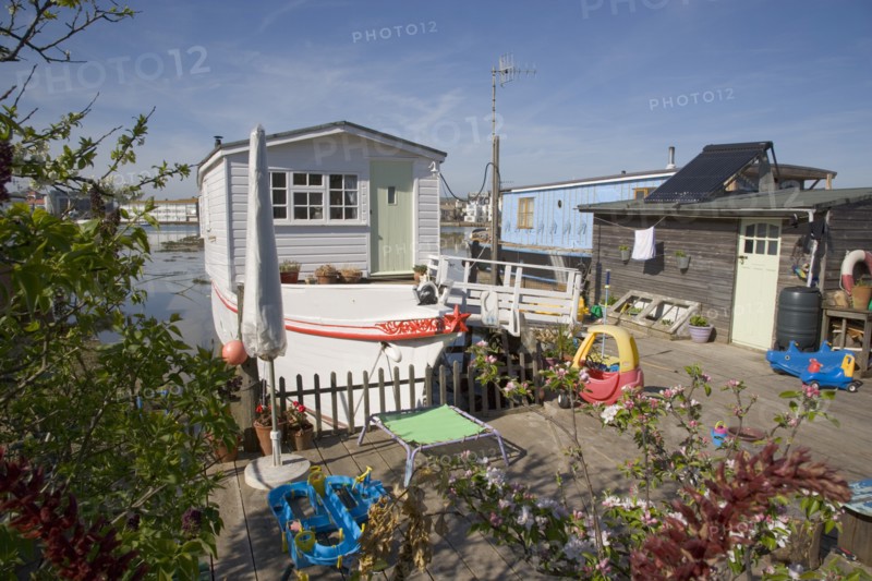 ENGLAND, West Sussex, Shoreham-by-Sea, Houseboat moored along the banks of the river adur.  Former barges and old boats converted into homes .