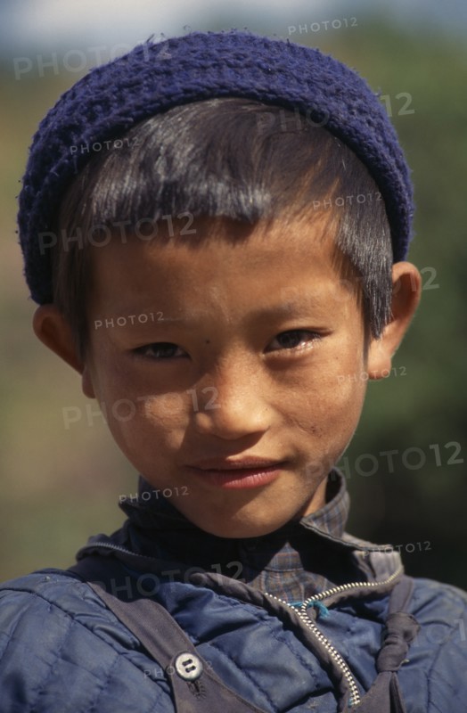 NEPAL, Annapurna Region, Bhadauri, Head and shoulders portrait of young Gurung boy in Bhadauri village