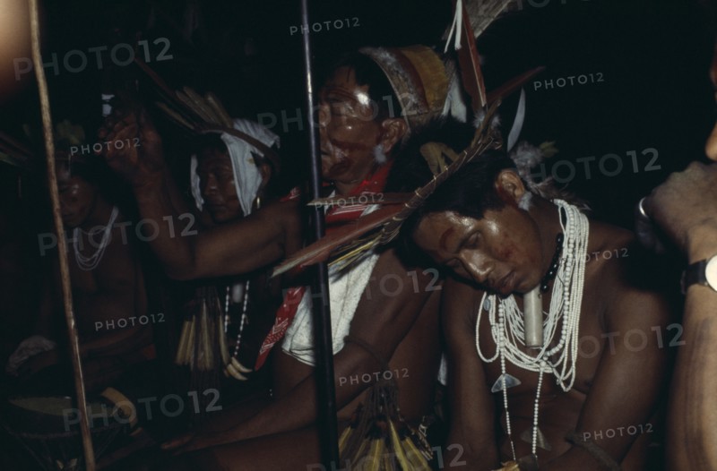 COLOMBIA, North West Amazon, Tukano Indigenous People, Barasana elders chanting  Bosco the headman in drugged sleep after ritual dance  Cristo an old shaman leads chant clutching hardwood prayer stave  All in hallucenogenic state after drinking potent Yaje juice  Tukano sedentary Indian tribe North Western Amazonia ayahuasca American Colombian Columbia Hispanic Indegent Latin America Latino Religion South America Tukano Religious