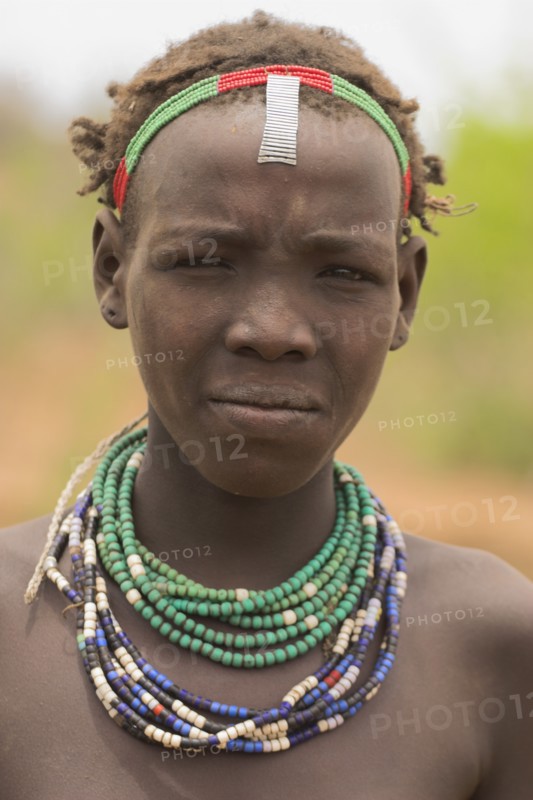 ETHIOPIA, Lower Omo Valley, Village near Omorate, Dassanech girl