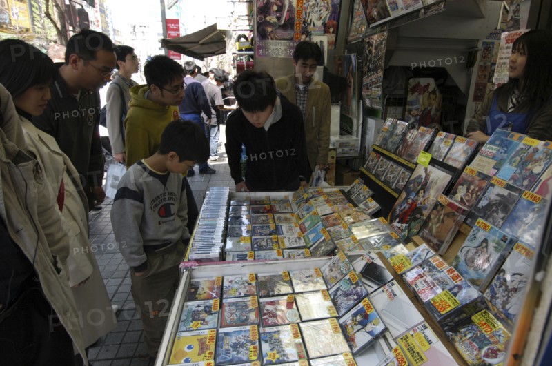 JAPAN, Honshu, Tokyo, Harajuku - boys and men shopping at a used software shop for video games