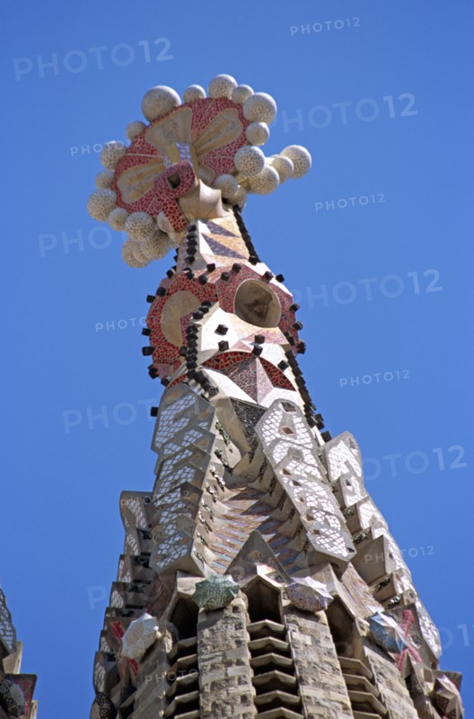 SPAIN, Catalonia, Barcelona, La Sagrada Familia colourful cathedral steeple detail.