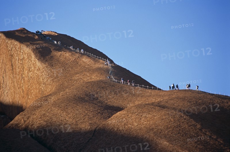 AUSTRALIA, Northern Territory, Uluru, "Kata Tjuta National Park, Mount Uluru, People climbing  Ayers Rock."