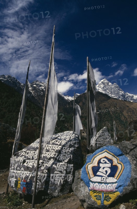 NEPAL, Everest Trek, Ghat, Mani Stones and Prayer Flags in Ghat Village.