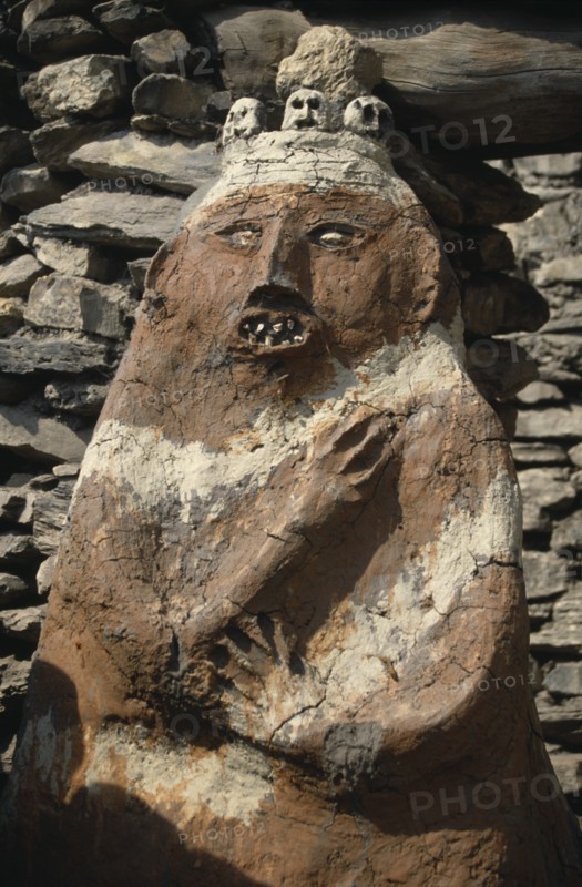 NEPAL, Annapurna Region, Jharkot, Circuit Trek. Male animistic protector deity beside the gateway to the old part of Jharkot
