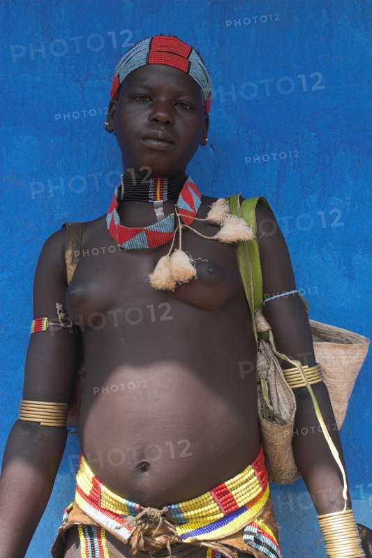 ETHIOPIA, Lower Omo Valley, Key Afir, Tsemay woman traditionally dressed at weekly market