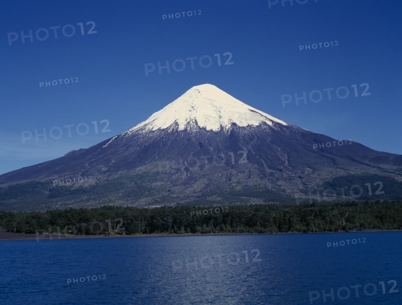 CHILE, Los Lagos, Osorno Volcano, Snow capped peak of volcano above lake near Puerto Montt.