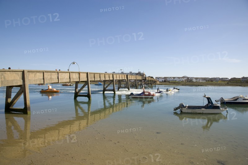 ENGLAND, West Sussex, Shoreham-by-Sea, Footbridge across the river Adur with waterskiers passing under.