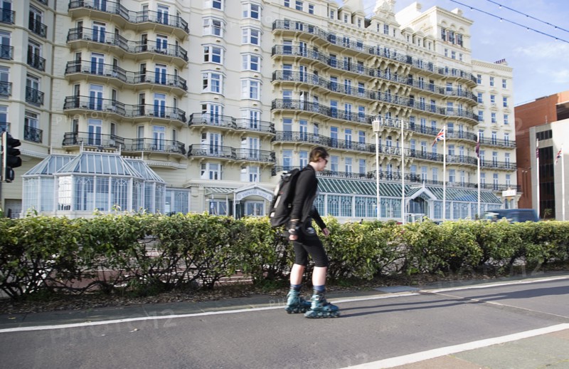 ENGLAND, East Sussex, Brighton, Rollerblading on the seafront promenade.