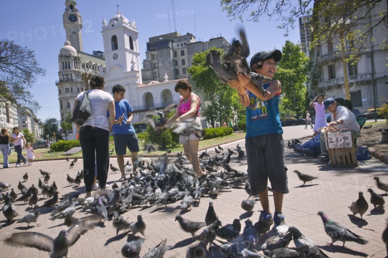 ARGENTINA, Buenos Aires, Feeding the pigeons in Plaza de Mayo.