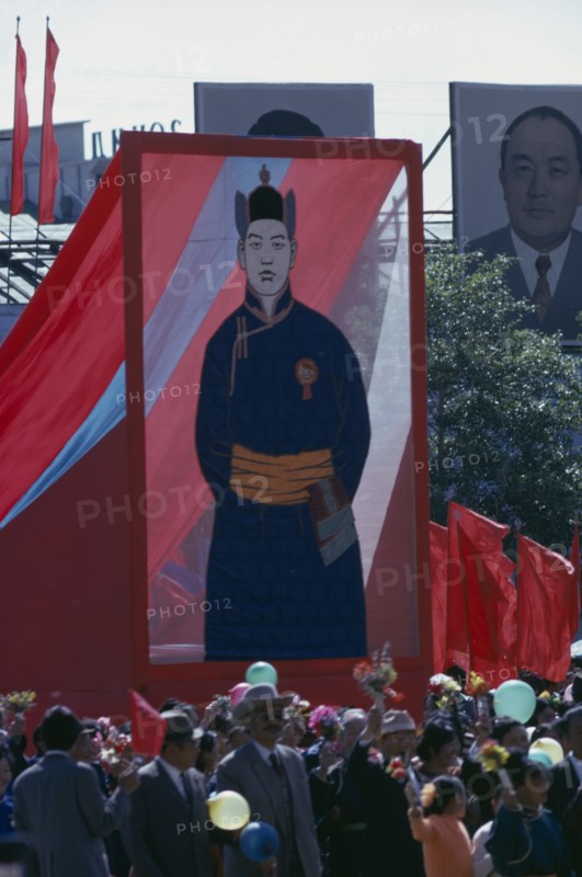 MONGOLIA, Ulan Bator, Nadam  Mongolian National Day. Parade of Communist Party members and workers carrying banners and posters of the first Mongolian President Sukhebator in foreground and other important Mongolian politburo members displayed in background. Ulaan Baatar East Asia Asian Baator Mongol Uls
