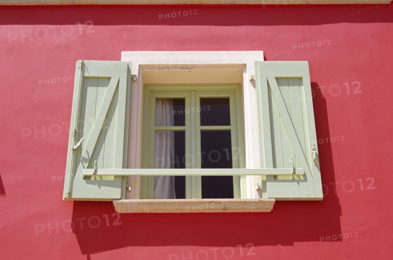 GREECE, Ionian Islands, Kefalonia, "Lixouri, Stil Tipaldou, Green and cream window and pink wall of house."