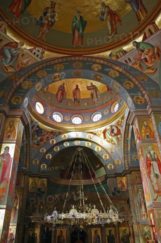 ISRAEL, Hazafon, Sea of Galilee, "Nazareth.  Interior of the Greek Orthodox Church of St. Gabriel also known as the Church of the Annunciation, located over the spring that fed Marys Well.  Interior domed ceilings and archways decorated with paintings of biblical scenes and the saints, wall hangings and tiled mosaics.  Ornate candelabra hanging from centre framed by arch."