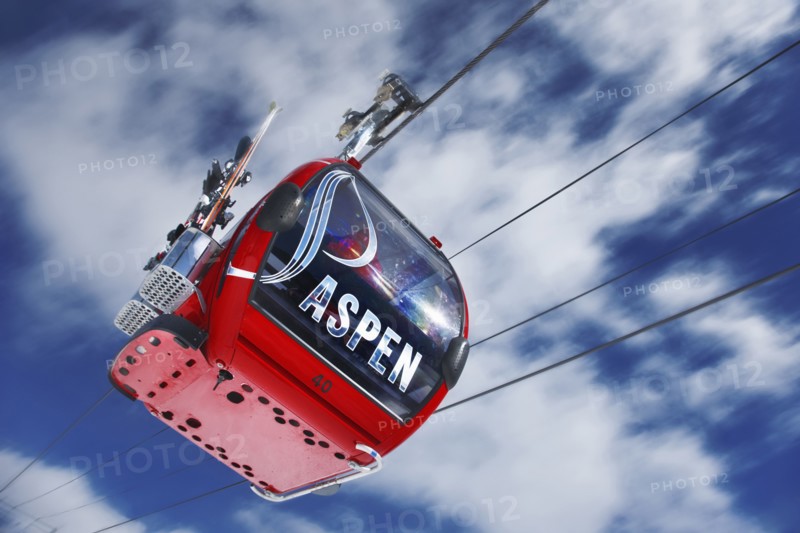 20091058 View cable car ski lift against blue sky with clouds. North America United States America White  WeatherTravelTransportDominant RedDominant WhiteDominant BlueRegion - North America Jon Hicks 20091058 USA Colorado Aspen