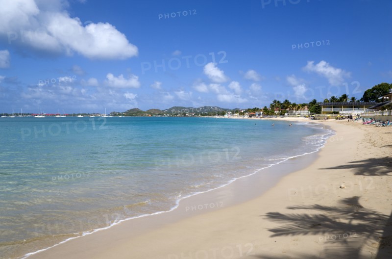 WEST INDIES, St Lucia, Gros Islet, Reduit Beach in Rodney Bay with tourists in the water and on the beach