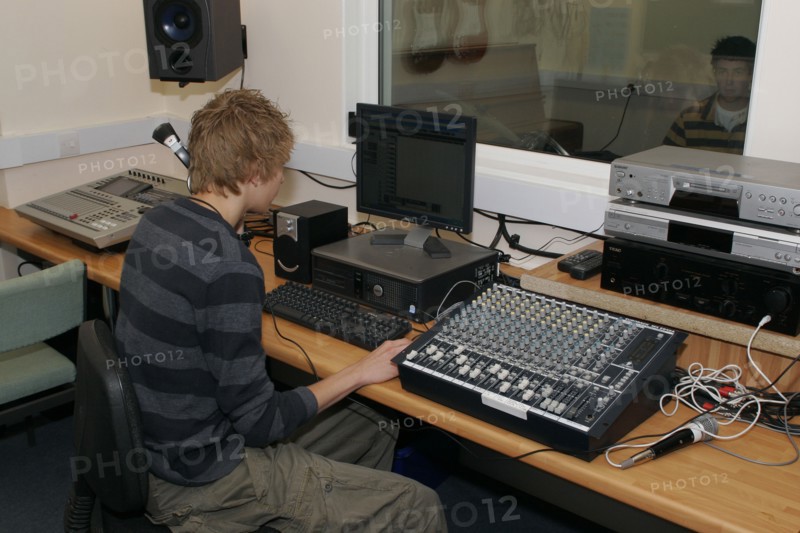 CHILDREN, Education, Secondary, Students using sound desk in school recording studio.