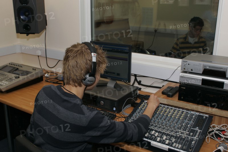 CHILDREN, Education, Secondary, Students using sound desk in school recording studio.