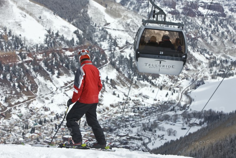 20091055 Skier slopes with cable car ski lift overhead passing by. Property Released American Automobile Automotive Cars Holidaymakers Motorcar North America Skiing Skis Tourism Tourist United States America  Dominant RedDominant WhitePeople - Portraits