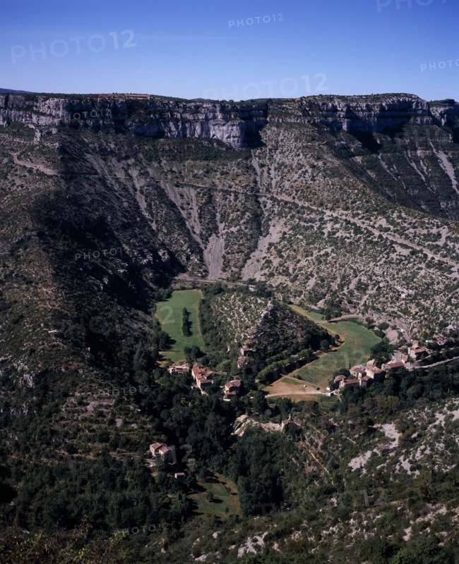 FRANCE, Midi-Pyrenees, Tarn, "Elevated view over Cirqe de Navacelles a landform created by glacial erosion, with former oxbow lake now dried up, beside small settlement."