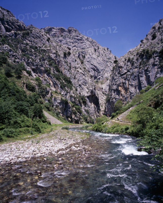 SPAIN, Asturias, Picos de Europa, "Garganta del Cares.  Rio Cares flowing towards gorge from the south.  Shallow, fast flowing water over rocks with steep eroded limestone cliffs beyond."