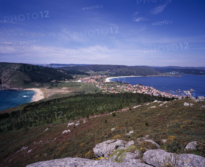SPAIN, Galicia, View north from Cap Fisterra with Praia do Mar de Fora on the left and the village of Fisterra on the right.