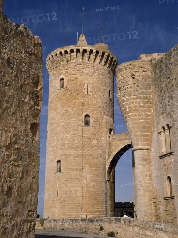 SPAIN, Balearic Islands, Mallorca, Palma.  Circular defence tower and bridge of fourteenth century Belver Castle with tourist visitor just seen above wall.