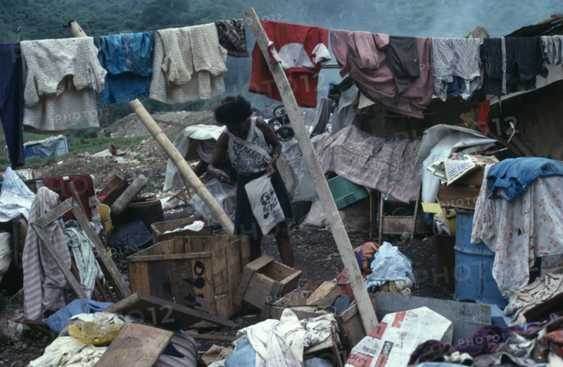 ECUADOR, Guayas Province, Guayaquil , Rubbish sorters house with a woman surrounded by clothes and other recycled items found in the city rubbish tip in barrio Guayas slum neighbourhood