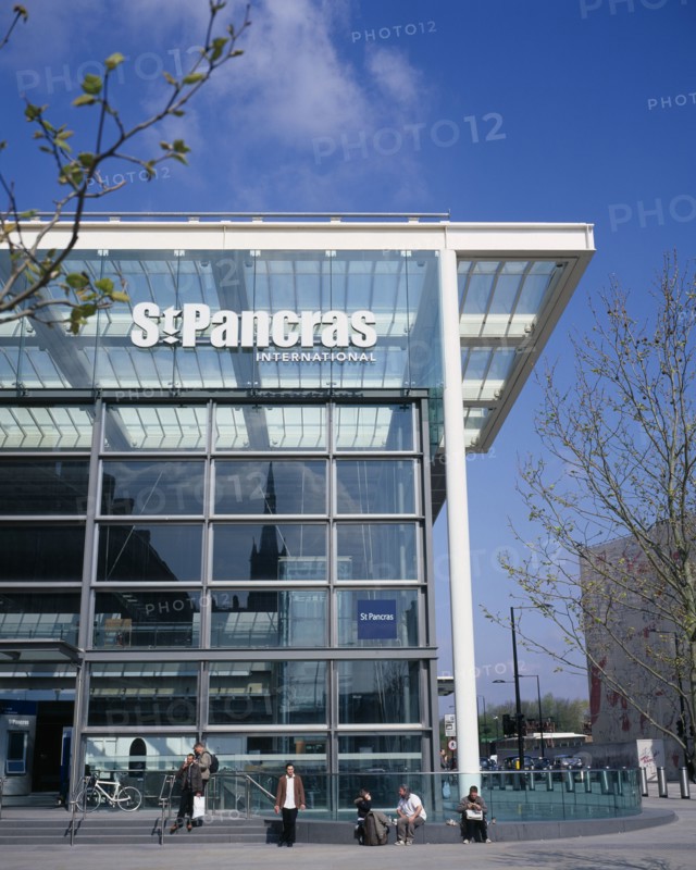 ENGLAND, London, St Pancras , St Pancras International exterior.  New security sealed terminal for Eurostar trains to continental Europe with passengers waiting on steps in the sunshine outside.