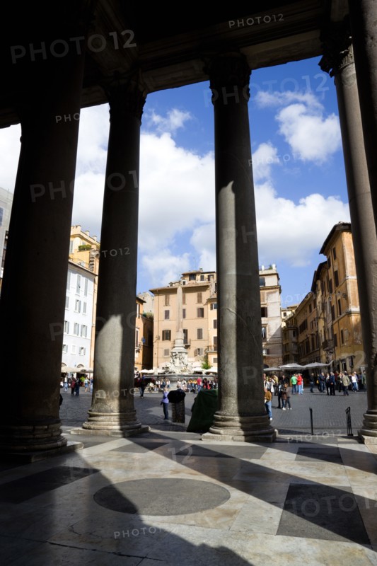 ITALY, Lazio, Rome, Piazza della Rotonda seen through the granite columns of the Pantheon with tourists walking in the square