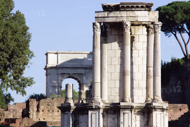ITALY, Lazio, Rome, The Temple of Vesta in the Forum with the Arch of Titus in the distance